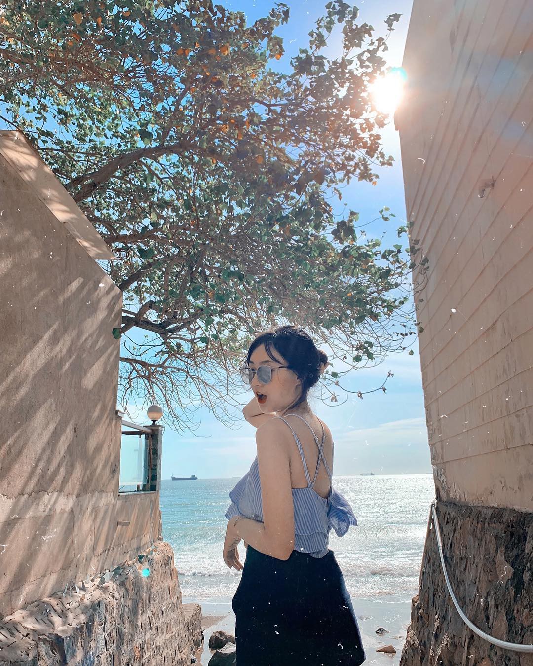 A female tourist posing on the beach