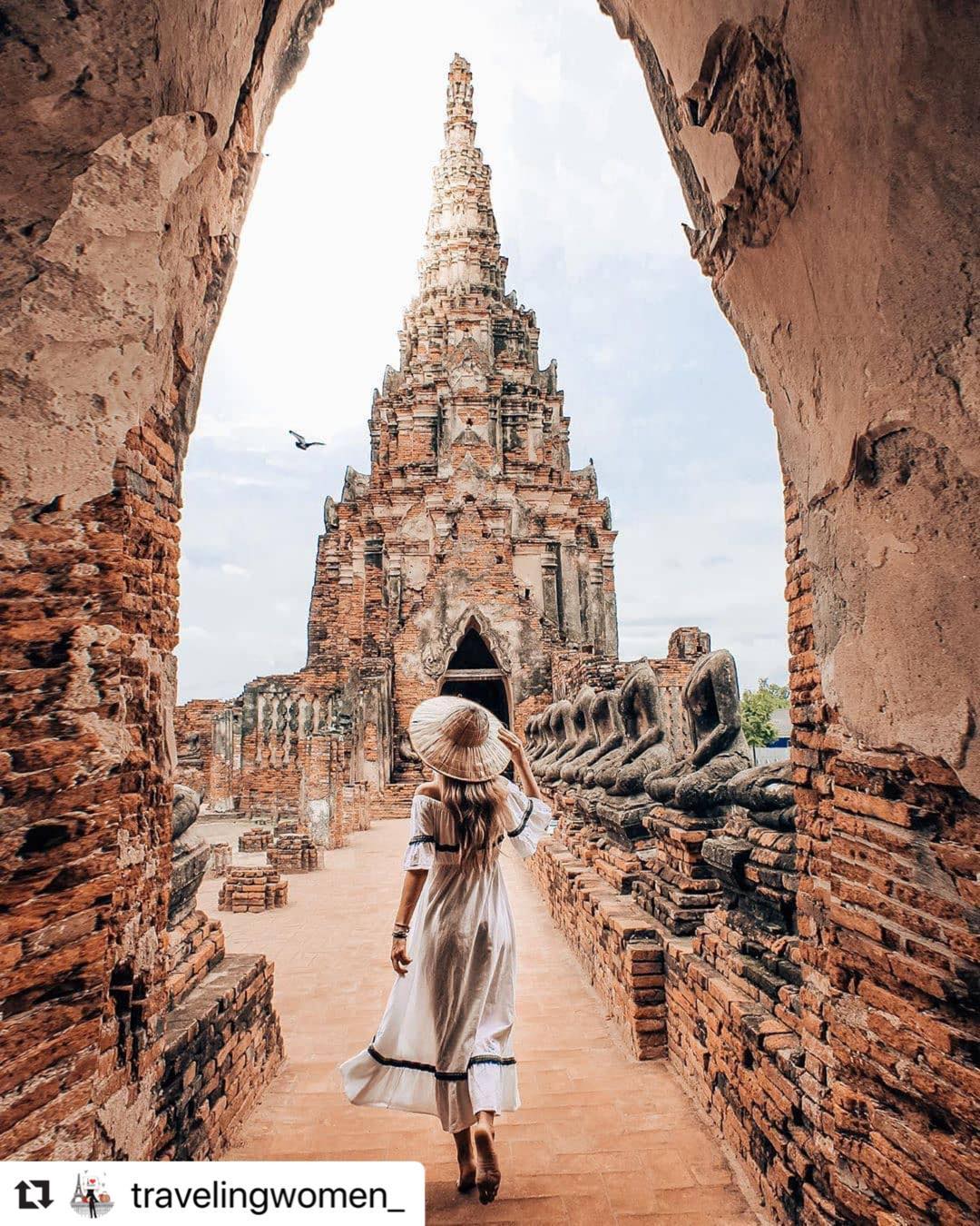 A lady posing along the entrance into an ancient temple ruin