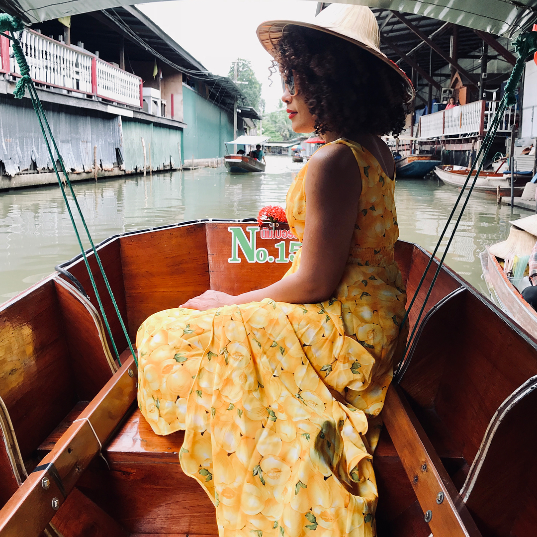 A lady posing in a boat along Damnoen saduak floating market