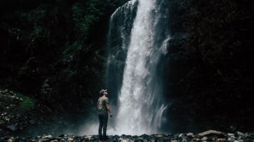 homem contemplando cachoeira