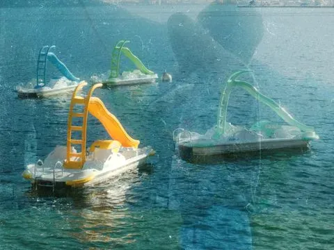 These are two of my favourite stills, capturing the colorful paddle boats that looked like toys, and by brother being young and playful
