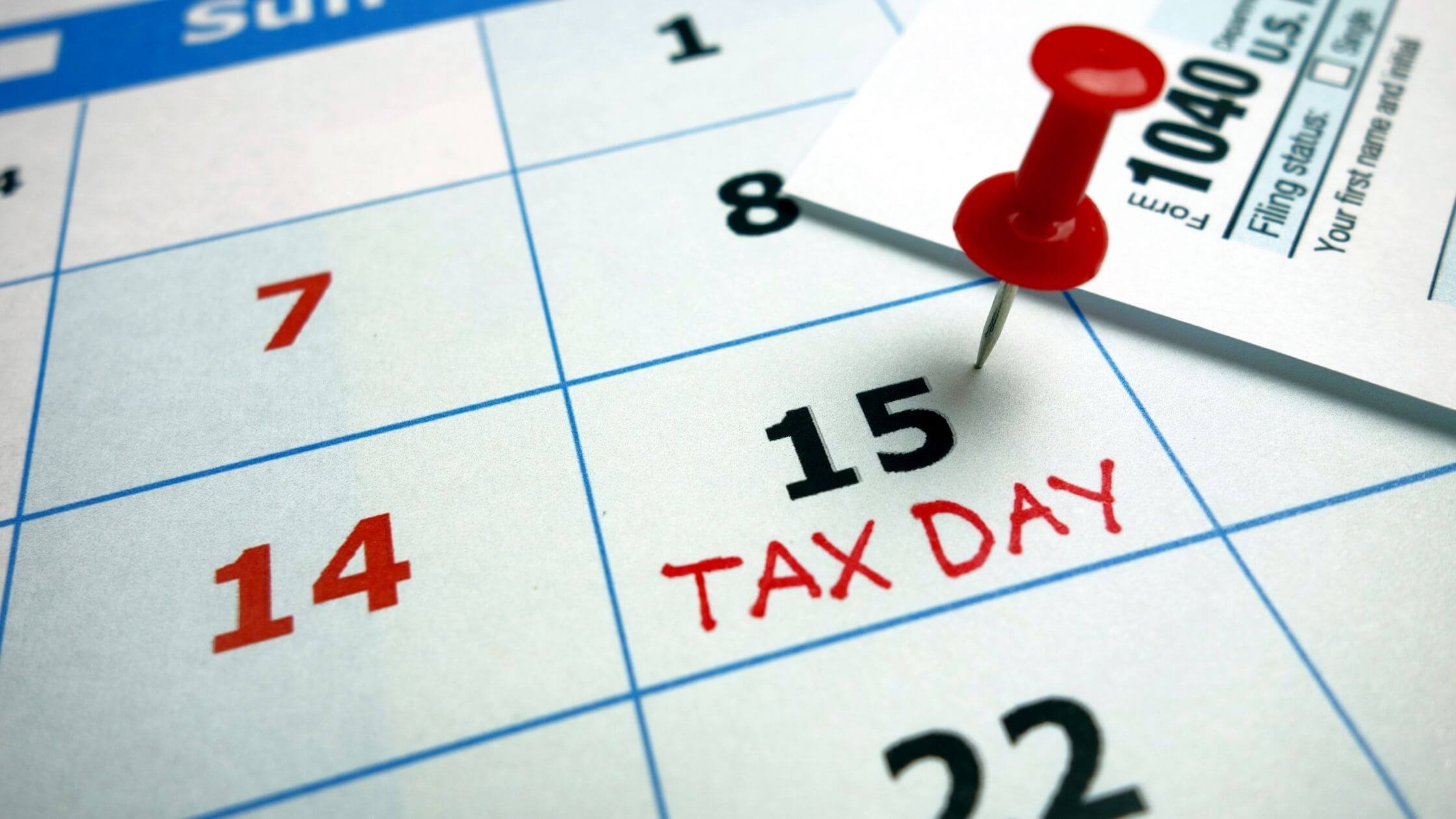 Tax Day is marked on a calendar with a red pin.