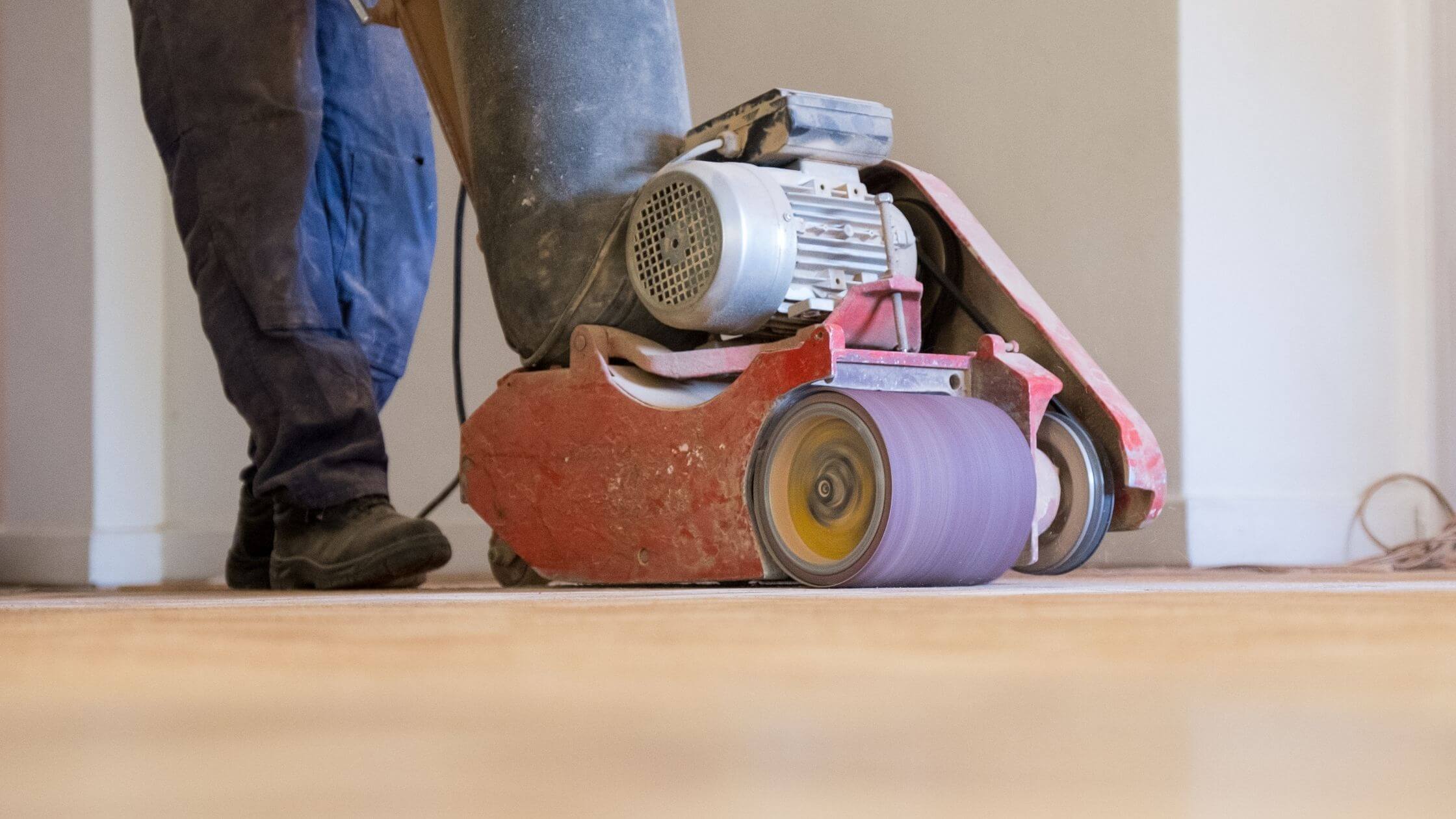 Wood floor getting sanded.