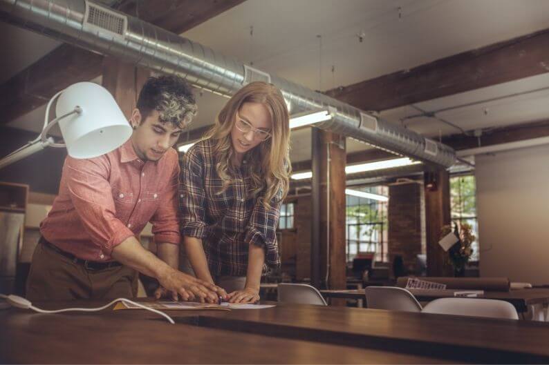 A man and woman discuss plans for the future franchise business. 