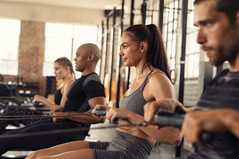 Group working out on a water rower at a CITYROW gym franchise