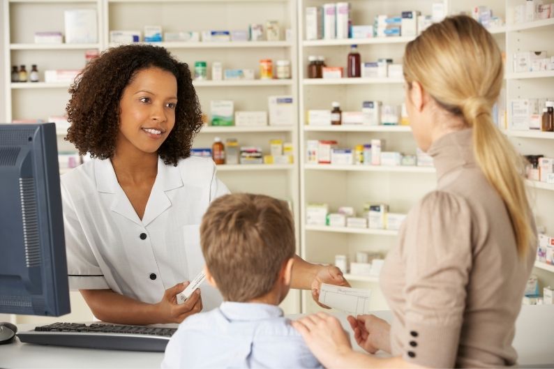 A pharmacist discusses medications with clients.