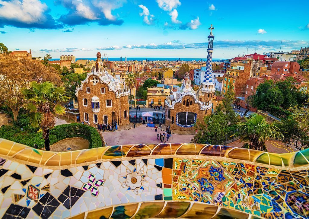 View from a mosaic balcony looking over iconic stone buildings and the city of Barcelona