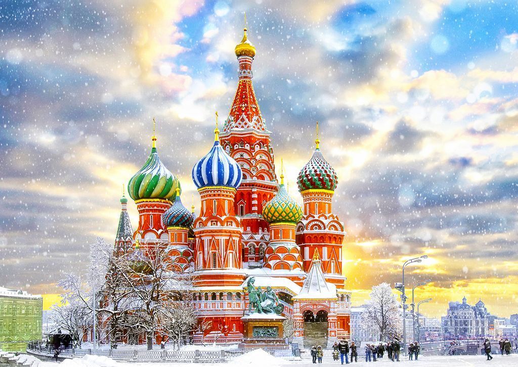 St. Basil's Cathedral in Moscow during a snowy winter sunset.