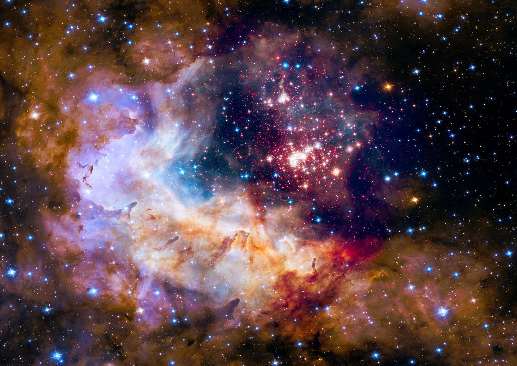 A deep space view of the Westerlund 2 star cluster embedded within a vibrant nebula.