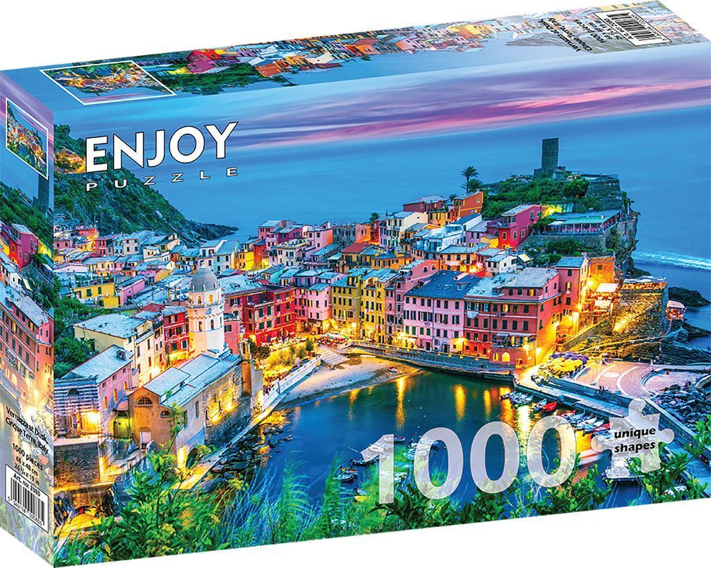 A panoramic photograph of the colorful coastal village of Vernazza, Italy, at twilight.