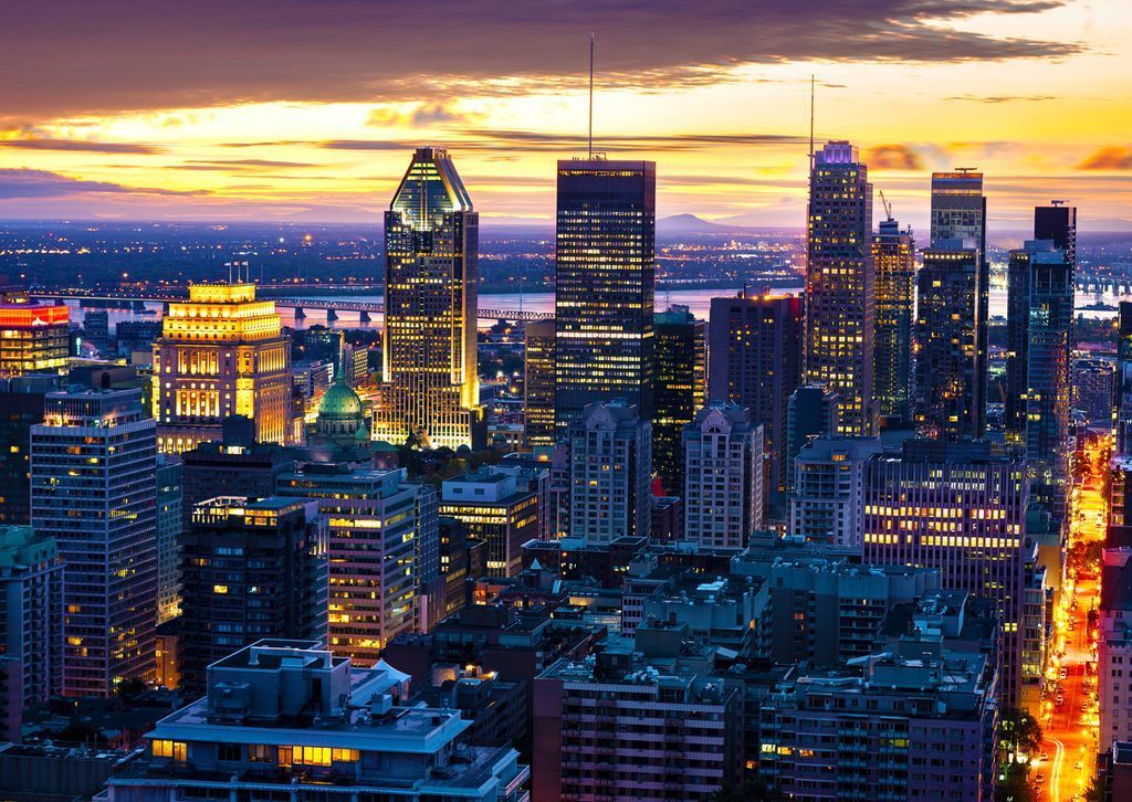 Aerial view of Montreal skyline at sunset with illuminated buildings