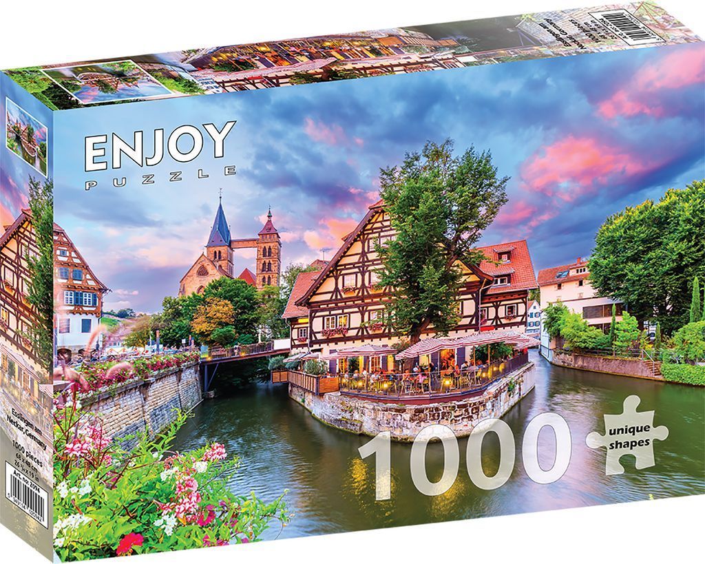 A riverside German town featuring half-timbered buildings and a stone church at sunset.