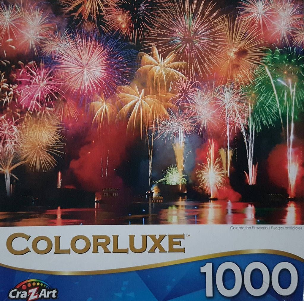 A vibrant night scene of multiple colorful fireworks exploding over a dark body of water.