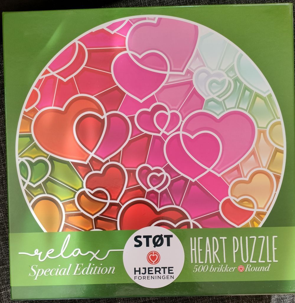 Stained glass style circular artwork featuring layered heart shapes in shades of pink, orange, and red against a green base.