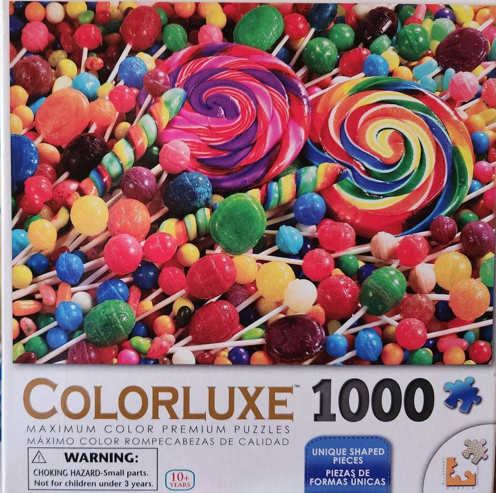A vibrant assortment of colorful lollipops and candies in a close-up overhead shot.