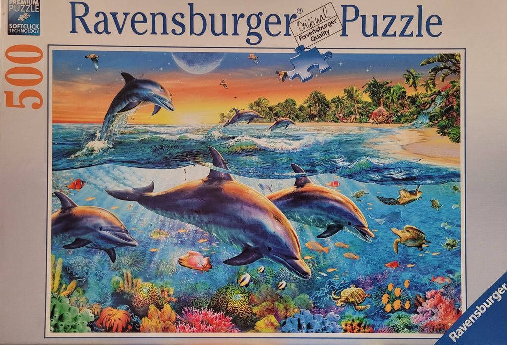 Dolphins swimming in a vibrant tropical ocean scene at sunset.