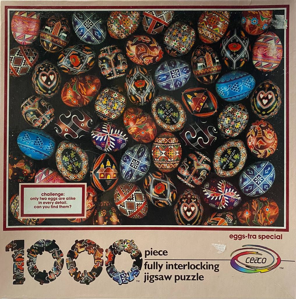 A collection of intricately decorated traditional Ukrainian pysanky Easter eggs arranged on a dark background.