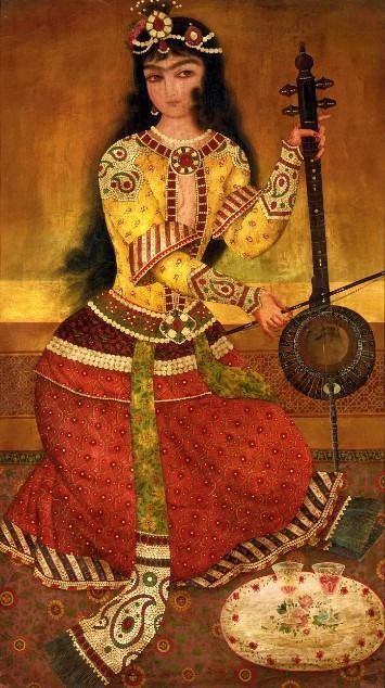 An elegant woman with dark hair playing a bowed string instrument while seated on a patterned rug.