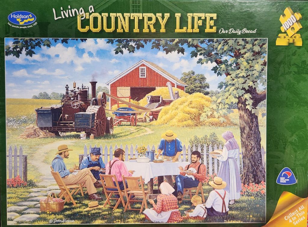 A pastoral scene featuring a harvest meal in front of a red barn and a vintage threshing machine.