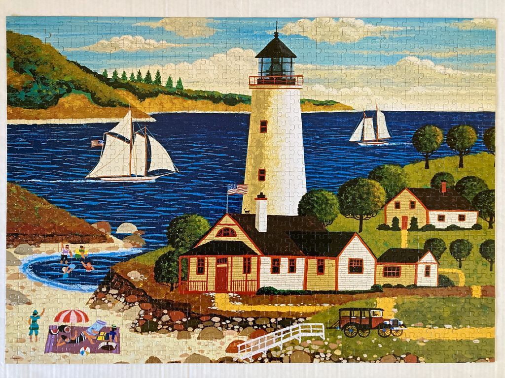 A painting of a coastal scene featuring a lighthouse, a cottage, sailboats, and a small beach with people relaxing.