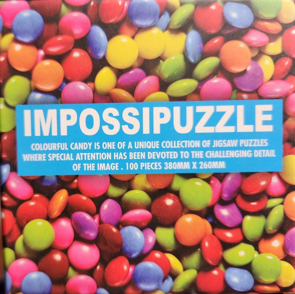 Close-up view of a dense pile of colourful, round, candy-coated chocolate buttons.