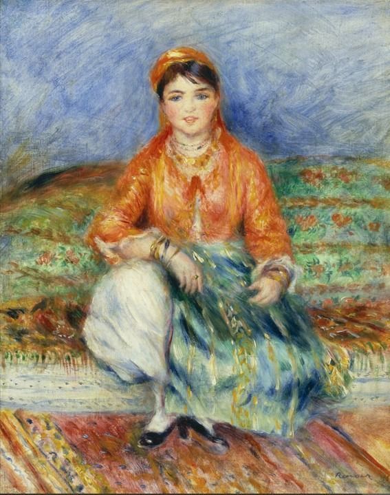 A seated young woman in colorful, exotic-style clothing against a textured blue background.