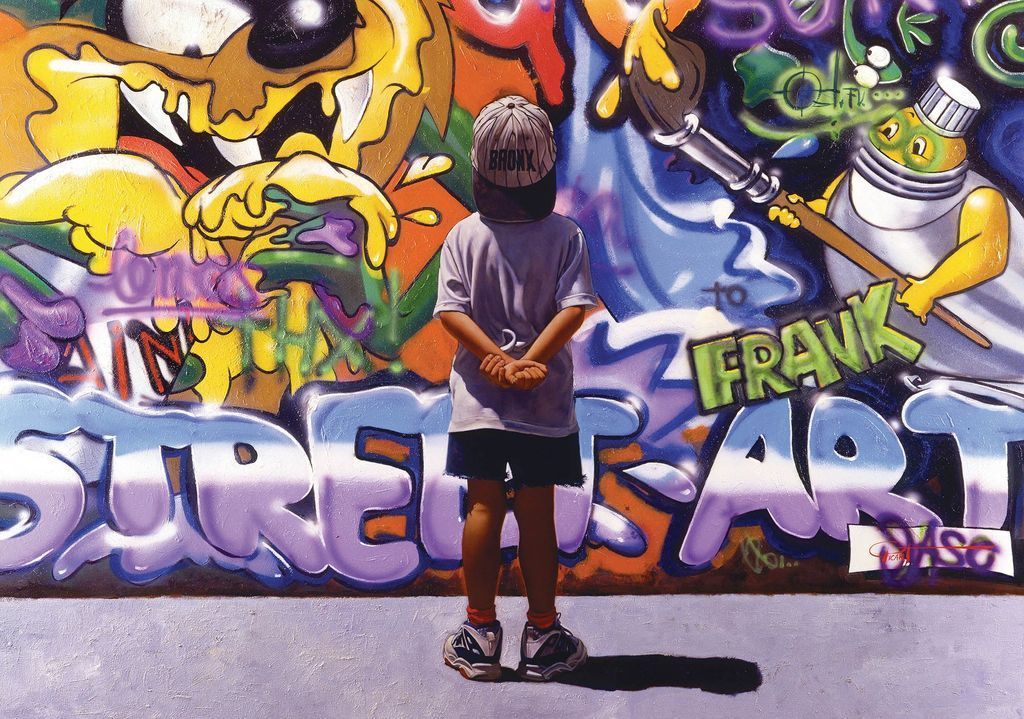 A young child wearing a Bronx baseball cap stands facing a vibrant, colorful graffiti-covered wall.