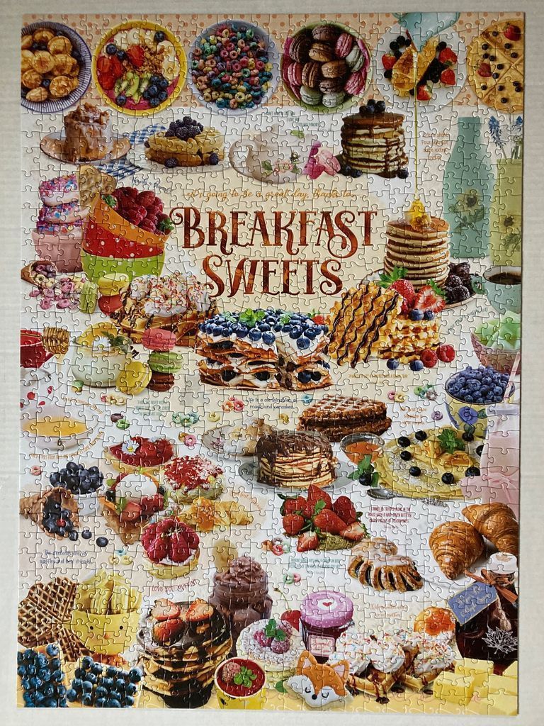 A collage of various breakfast pastries, pancakes, and fruit on a light polka-dot background.