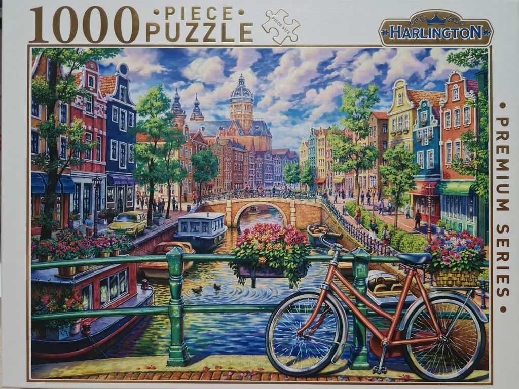 An oil-style painting of an Amsterdam-style canal scene featuring a bicycle, narrow boats, and ornate townhouses.
