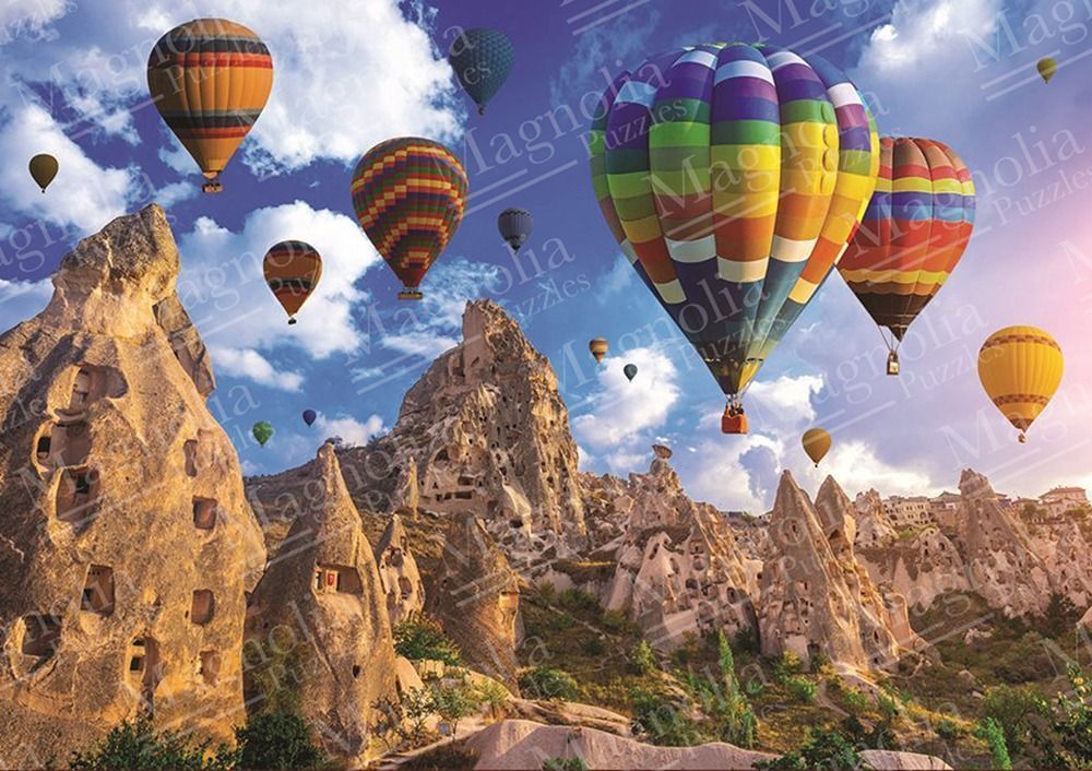 A collection of colorful hot air balloons floating over the fairy chimney rock formations of Cappadocia.