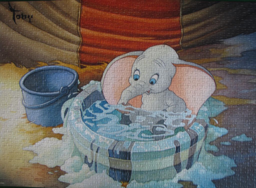 Dumbo the elephant bathing in a tub with soap bubbles