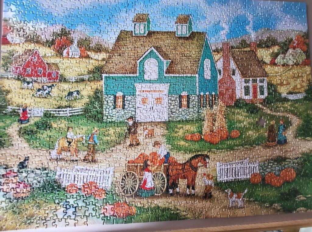 A rural autumn scene featuring a large teal barn, a horse-drawn wagon, and people celebrating the harvest.