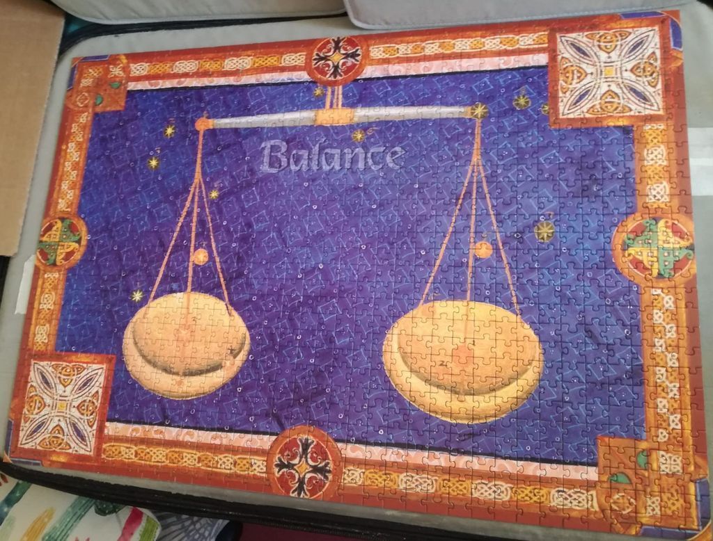 A scale of justice illustration set against a deep purple background with Celtic-style decorative borders.