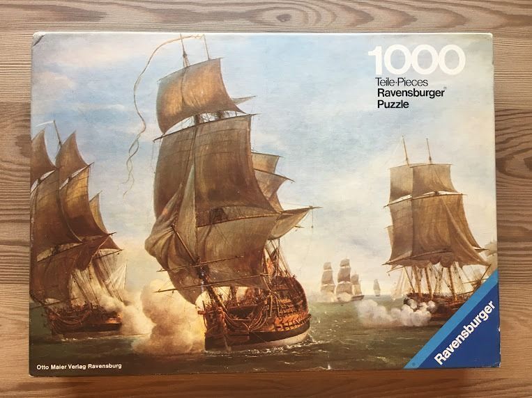 Oil painting of three large sailing ships engaged in a naval battle with smoke on the sea.