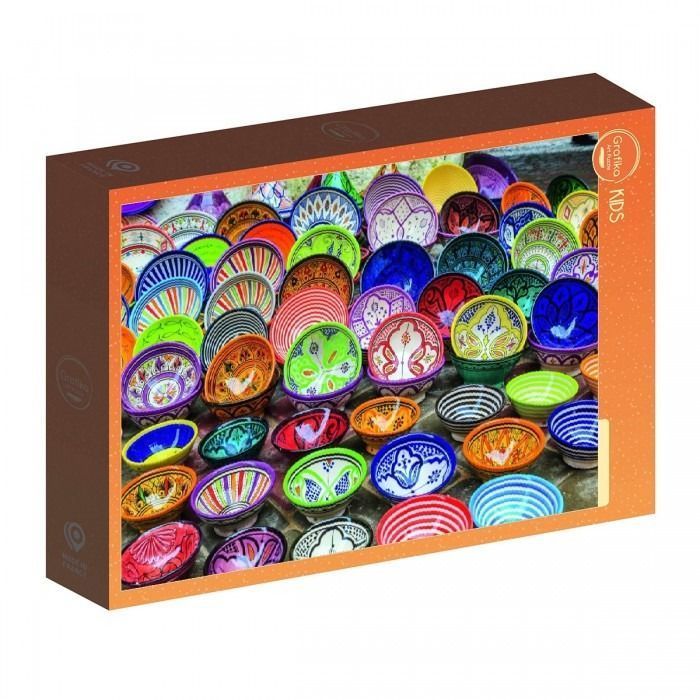 A high-angle photograph showing a dense collection of colorful, patterned ceramic bowls clustered together.