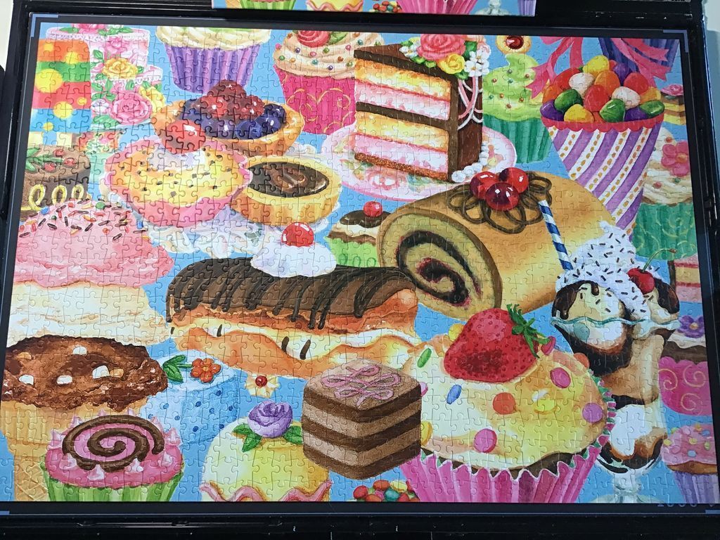 A dense illustration of various colorful cakes, cupcakes, and pastries on a light blue background.