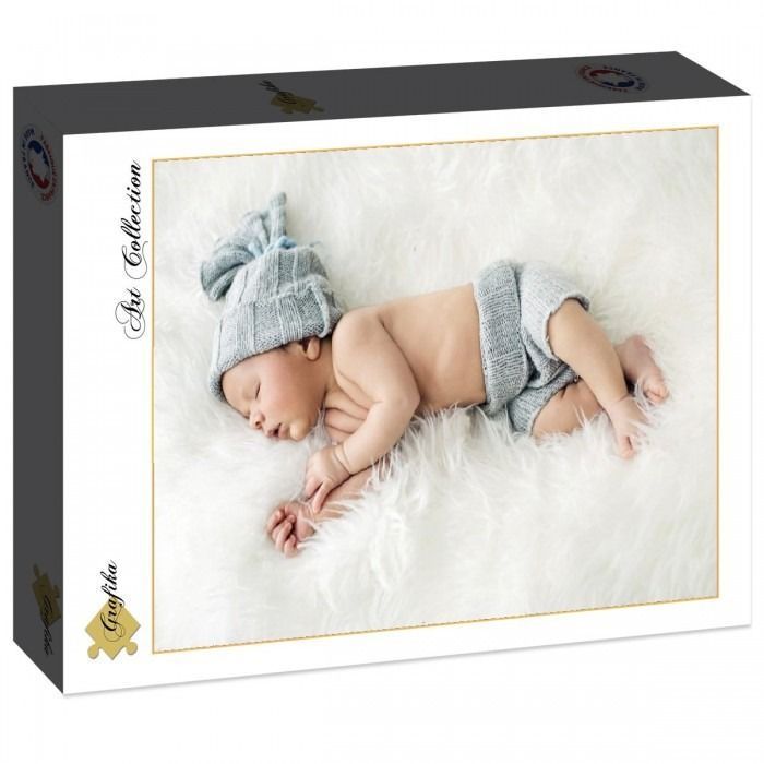 A newborn baby sleeping on a white faux fur blanket, wearing a matching grey knit hat and bloomers.