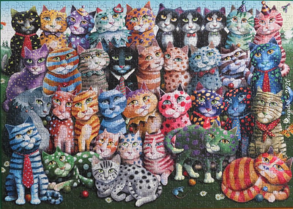 A dense illustration of many whimsical, vibrantly coloured cats arranged in rows against a green background.
