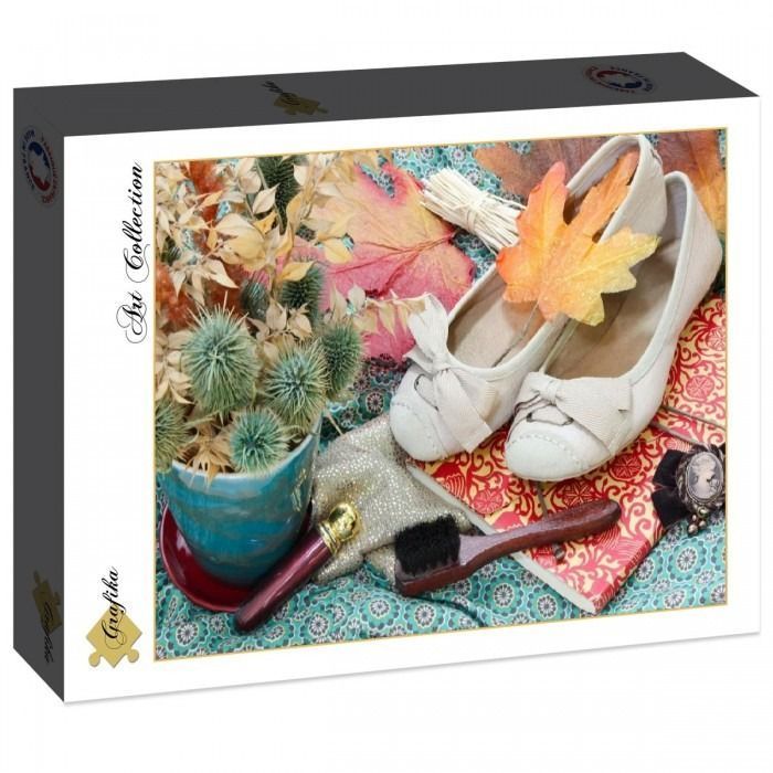 Still life featuring a pair of off-white ballet flats, a blue planter with dried plants, and autumn leaves.