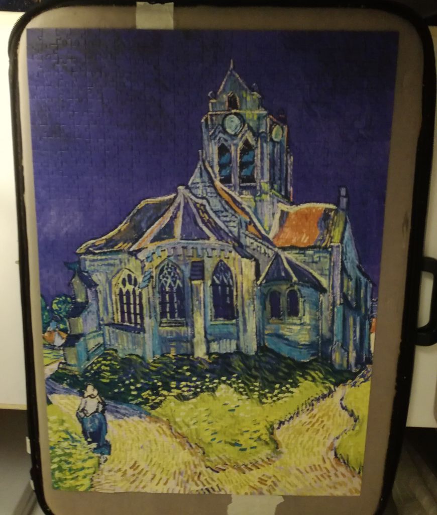 Vincent van Gogh's painting of The Church at Auvers, featuring a gothic cathedral against a deep blue sky.