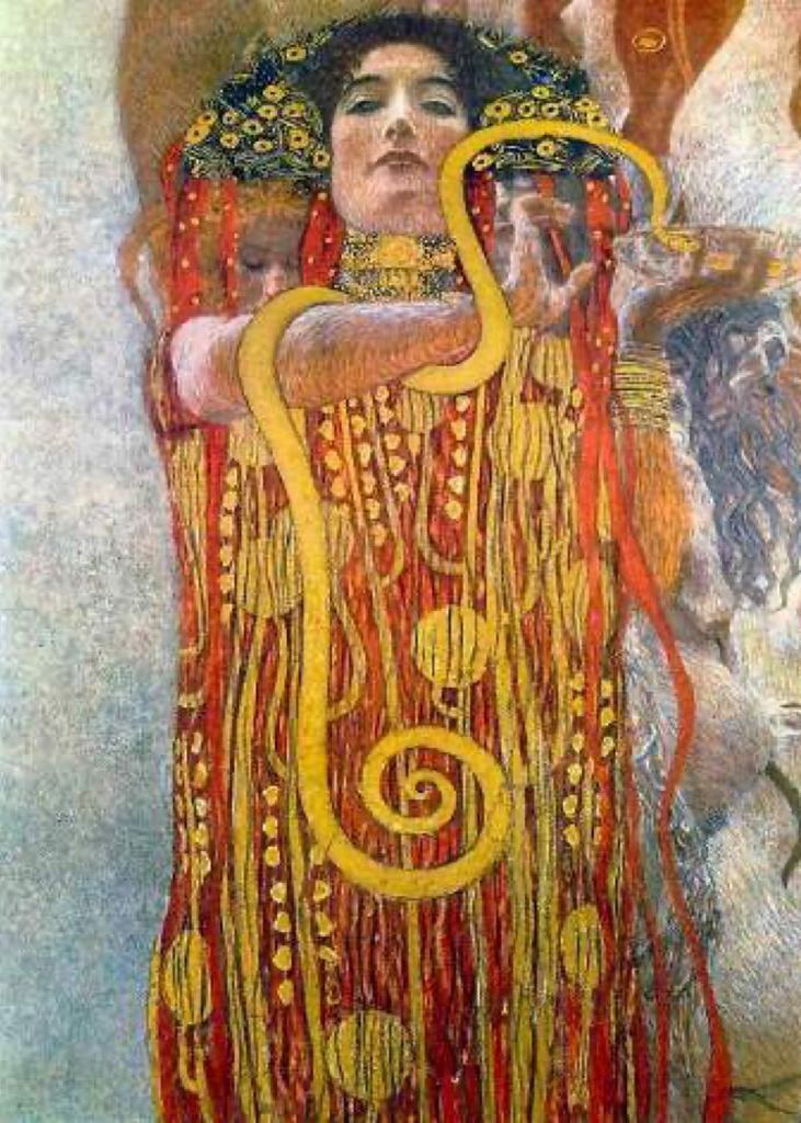 A woman with dark hair and a gold choker adorned with a large, golden serpent wrapping around her body.