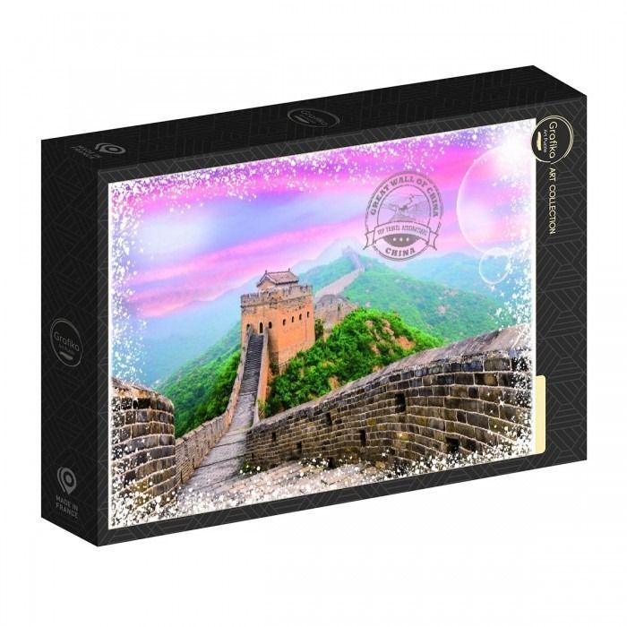 A photograph of the Great Wall of China under a bright pink and purple sunset sky.