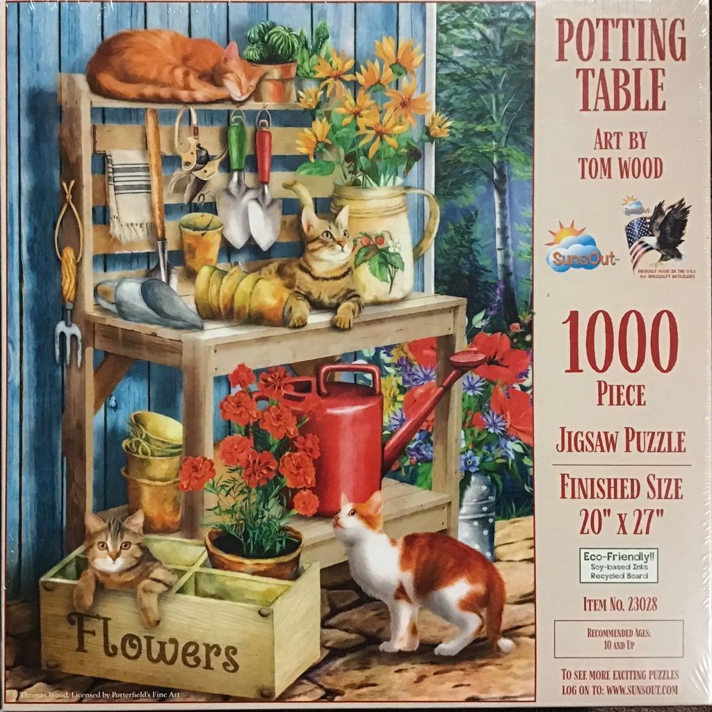 A potting table scene featuring three cats, assorted gardening tools, and potted flowers.