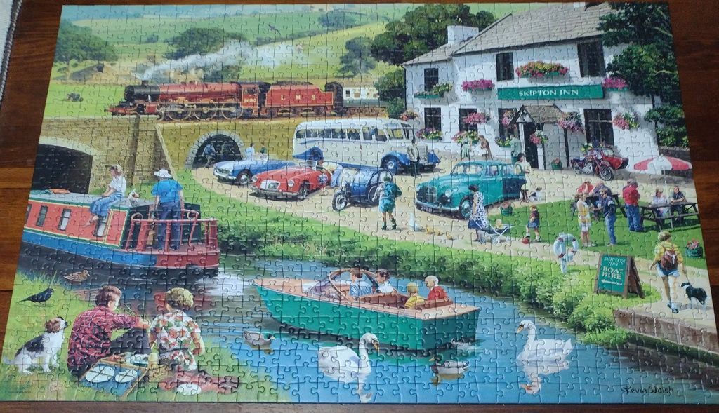 An illustration of a rural British canal scene featuring a steam train, the Skipton Inn, and various vintage vehicles.