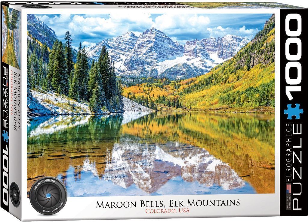 The snow-capped Maroon Bells mountains in Colorado reflected in a crystal-clear lake surrounded by autumn foliage.