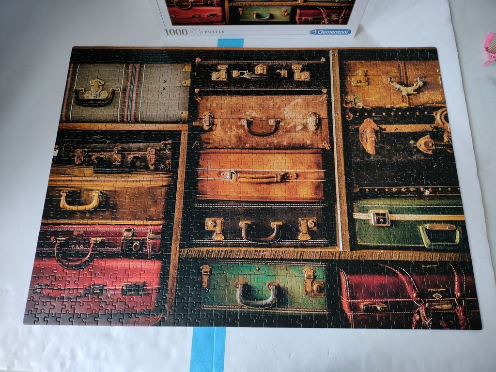 A collection of stacked vintage suitcases in various colours and textures.