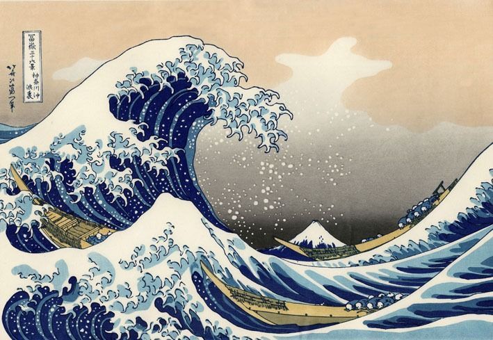 A towering cresting wave looming over three wooden boats with Mount Fuji in the background.