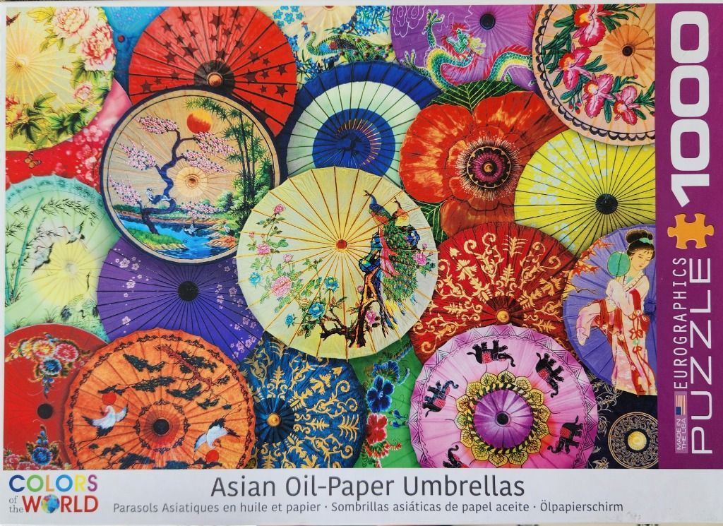 A collection of vibrant, overlapping traditional Asian oil-paper umbrellas featuring floral, animal, and landscape art.