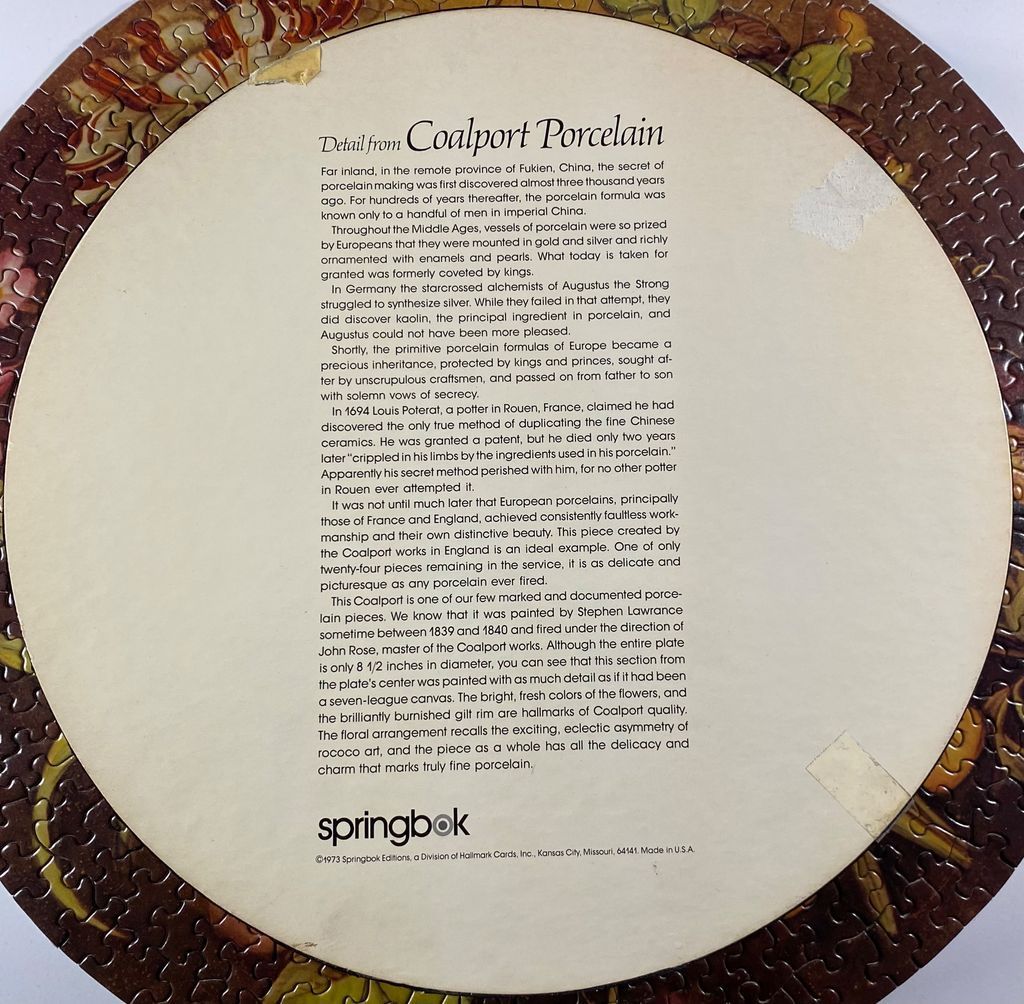 Fine porcelain plate with detailed floral design and text.