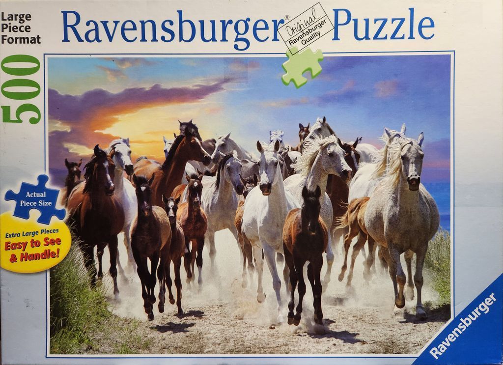 A herd of horses running across a dusty path under a vibrant sunset sky.